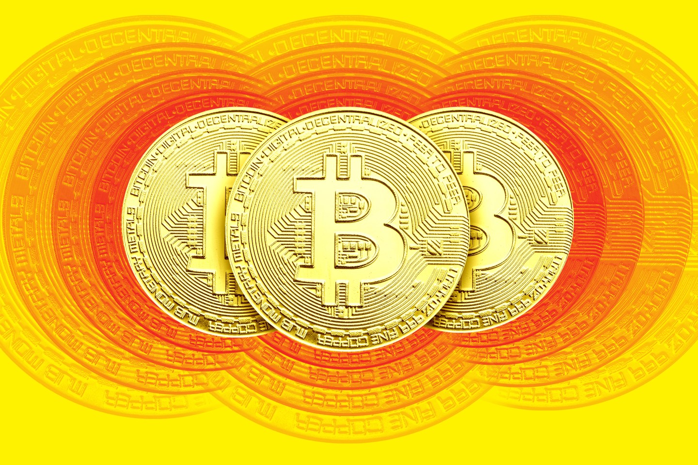 Three Bitcoins disappearing into view.