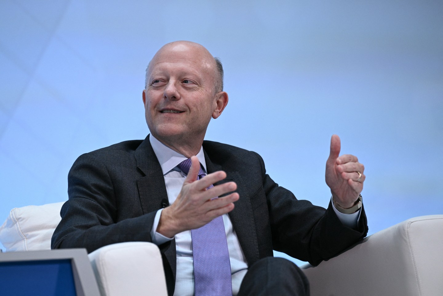 Man in a suit speaks while sitting
